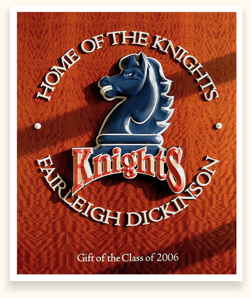 Carved Home of the Knights sign with a sculpted blue knight for Fairleigh Dickinson University