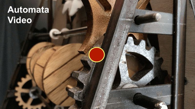 Close-up of the wood and metal gears inside the hand-built mechanical sign automata