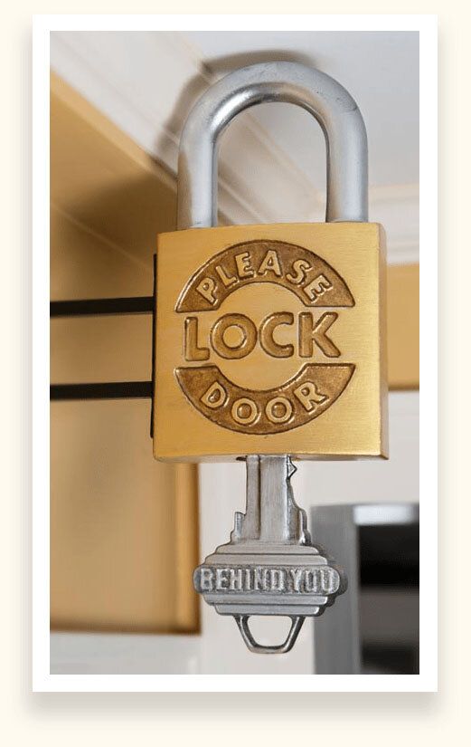 Sculpted brass padlock and key sign reading Please Lock Door and Behind You