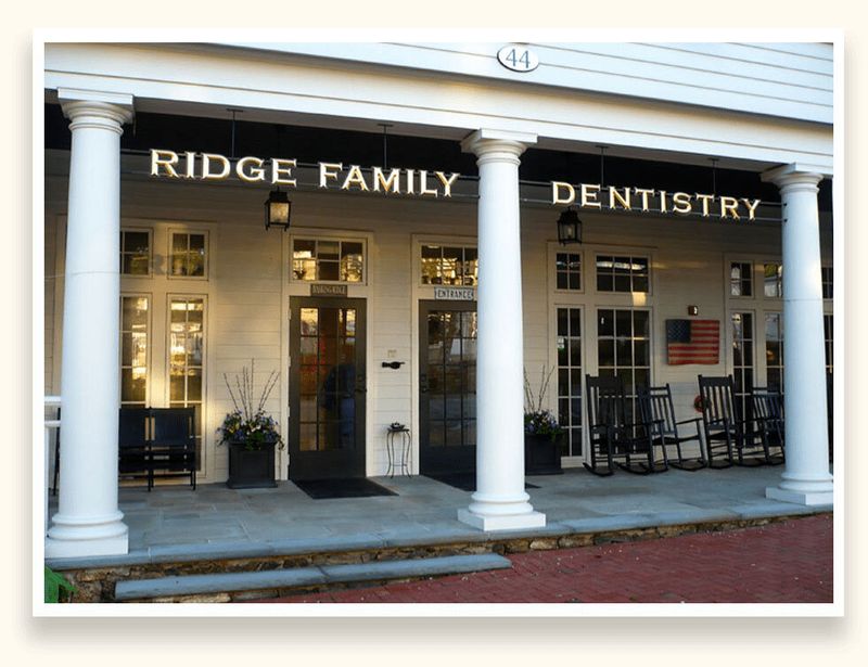 Gold leaf dimensional letters for Ridge Family Dentistry on a black storefront fascia