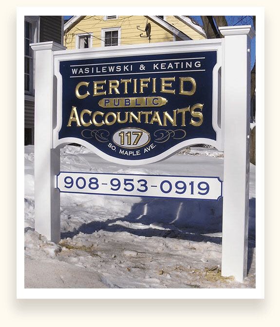 Navy carved sign with 23K gold leaf lettering for Wasilewski and Keating Certified Public Accountants