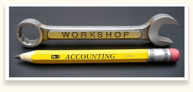 Sculpted oversized wrench and pencil used as workshop and accounting department signs